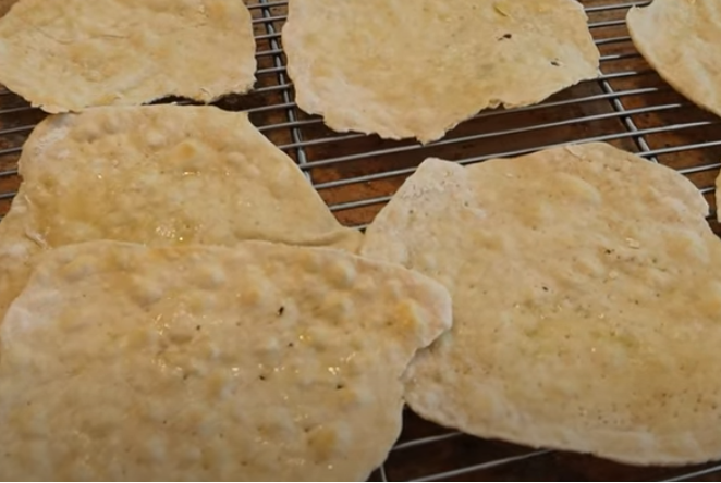 matzo with olive oil on top on a cooling rack